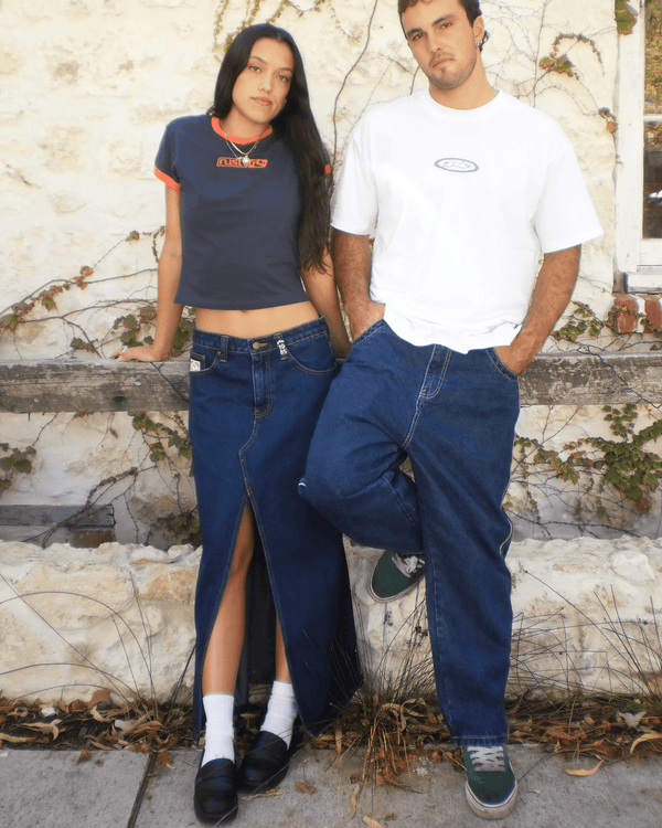 Rusty Celeste denim maxi skirt paired with casual tops in an outdoor setting.