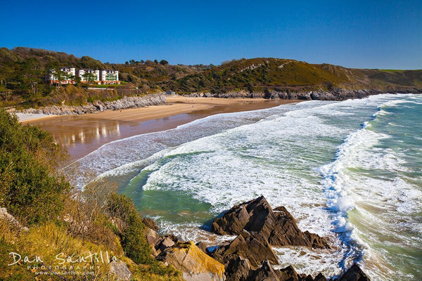 Dan Santillo 30cm x 40cm framed print featuring Caswell Bay's scenic coastline.