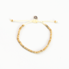 Coconut wood bead bracelet with adjustable cord and button clasp.