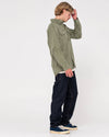 Model wearing Rusty Steven Straight Fit Jean styled with a green shirt and sneakers.