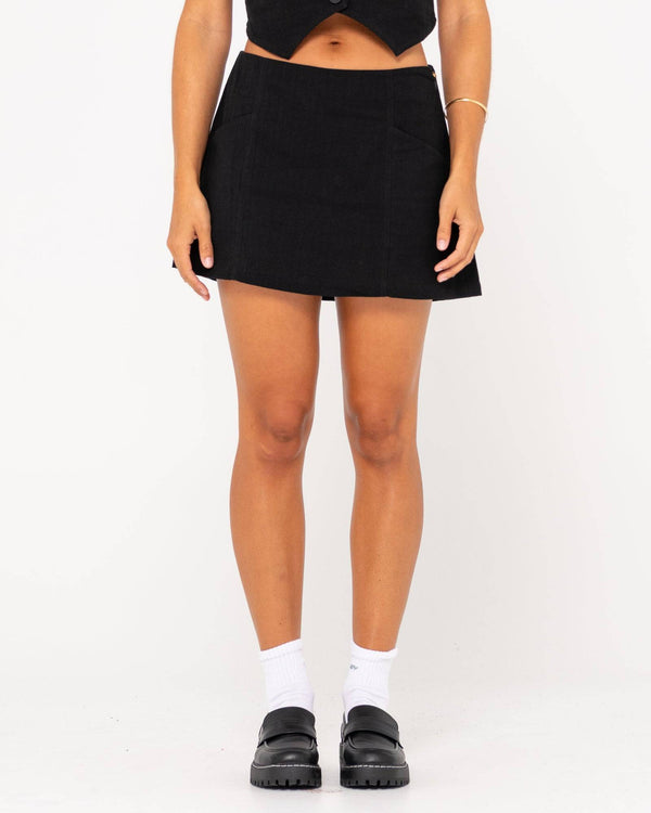 Front view of Rusty Sicily Mid Rise Mini Skirt in black.