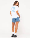 Full back view of Rusty Jill Standard Fit Tee paired with denim shorts.