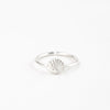 Minimalist silver shell adjustable ring displayed on a white background.