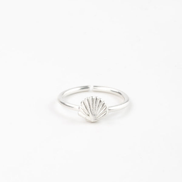 Minimalist silver shell adjustable ring displayed on a white background.