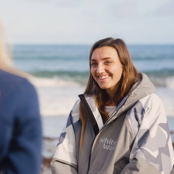 White Water Adults Hard Shell Robe in Arctic Camo/Grey, lifestyle shot by the beach.