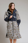 Leopard print White Water robe with black accents, modeled by a smiling woman.