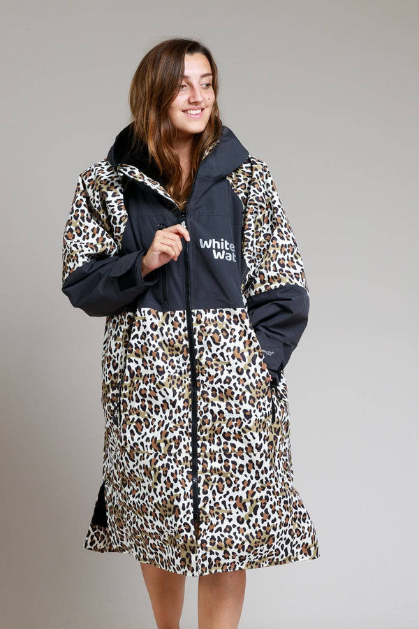 Leopard print White Water robe with black accents, modeled by a smiling woman.