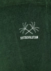 Close-up of Sisstrevolution Sofia Pant logo with palm tree embroidery in North Green.