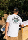 Man wearing Vissla Super Wolf Premium Pkt Tee outdoors with graphic back print.