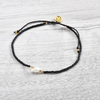 Stylish Pineapple Island Long Beach Anklet LBE-041 with black beads and gold accents.