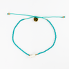 Turquoise beaded shell anklet with adjustable cord and gold accents.