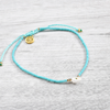 Turquoise beaded Pineapple Island bracelet SH-043 with gold charm.