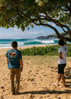 Two men on a beach, one wearing the Vissla Psychedelic Palms Tee.