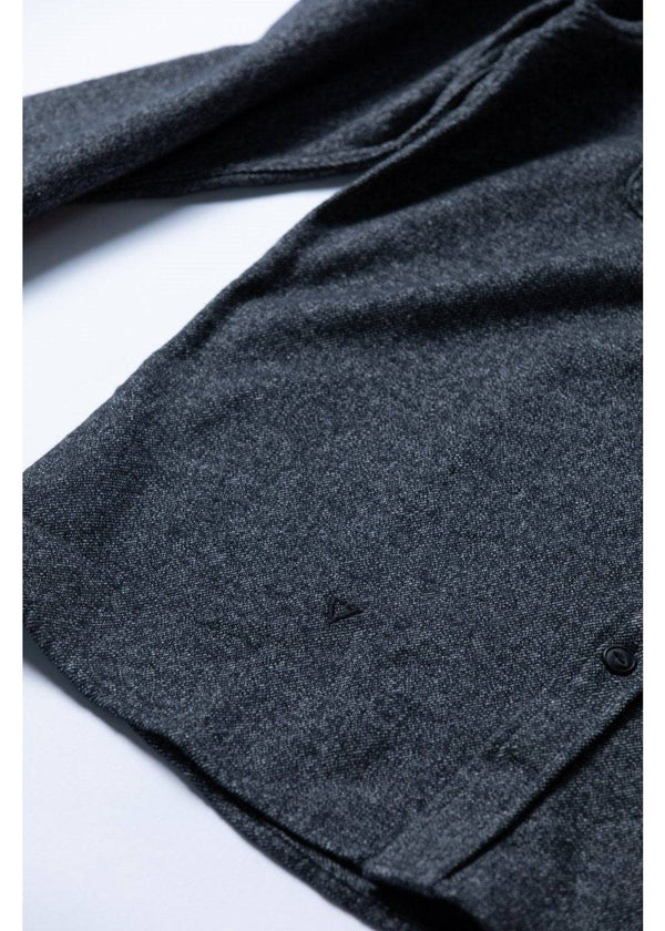 Close-up of Vissla Shaper Eco Flannel fabric and hem details in black.