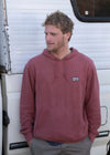 Man wearing Vissla Solid Sets Eco Po Hoodie in SRD color, casual outdoor look.