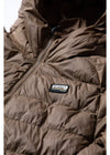 Close-up of Vissla Pacific Packable Eco Puff Jacket in brown with logo detail.