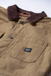 Close-up of Vissla Peterson Jacket chest pocket with logo patch and brown collar.