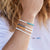 Woman wearing Pineapple Island Savu Puka Shell & Frosted Glass Bracelet in turquoise.