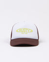 Front view of Rusty Bless You Trucker Cap showcasing logo design.