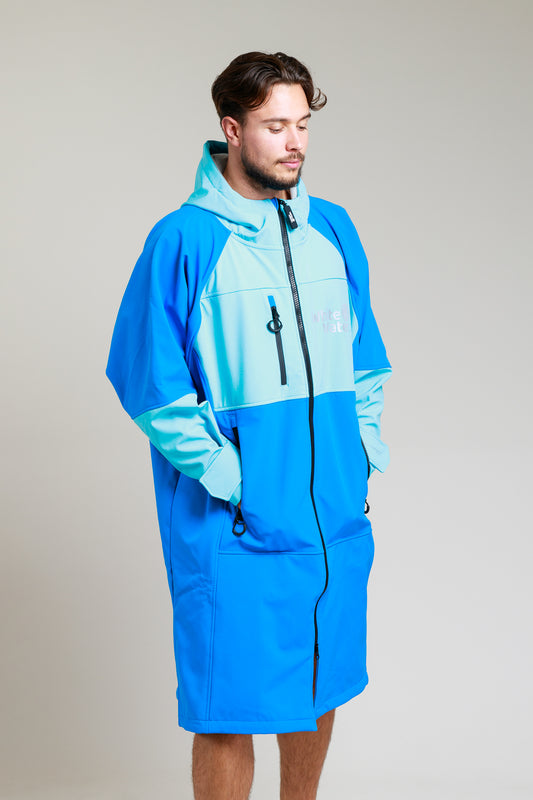 White Water Adult Soft Shell Robe in cobalt blue worn by a man, featuring a zip-up front and pockets.