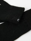 Close-up of Rusty Hold Up Gloves showcasing the black knit fabric and logo detail.