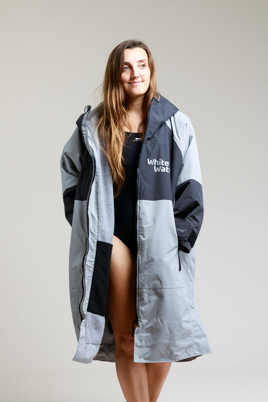 White Water Adult Hard Shell Robe in grey, open front, modeled by a woman.