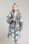 Child showing interior fleece lining of White Water Kids Hard Shell Robe in Arctic Camo/Grey.