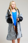 Girl wearing Grey White Water kids robe, revealing swimwear underneath.