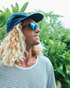 Close-up of man wearing I-Sea Logan sunglasses with black frame and blue polarised lenses.