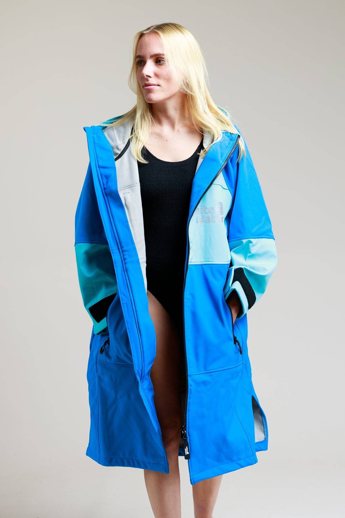 SSBLUE3 White Water Adult Soft Shell Robe in cobalt blue worn by a woman, showcasing its hood and long design.